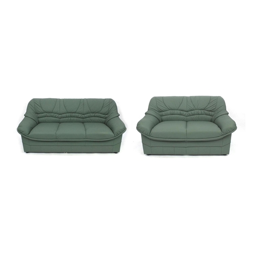 65 - Mint green leather three seater settee and two seater settee, the larger 180cm long