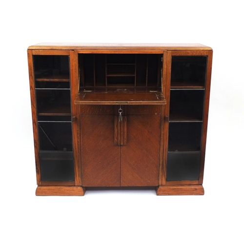 2037 - Art Deco walnut cabinet fitted with a pair of glazed doors, each enclosing three adjustable shelves ... 