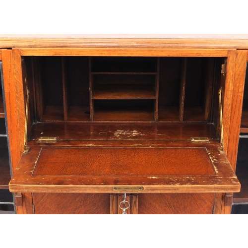 2037 - Art Deco walnut cabinet fitted with a pair of glazed doors, each enclosing three adjustable shelves ... 