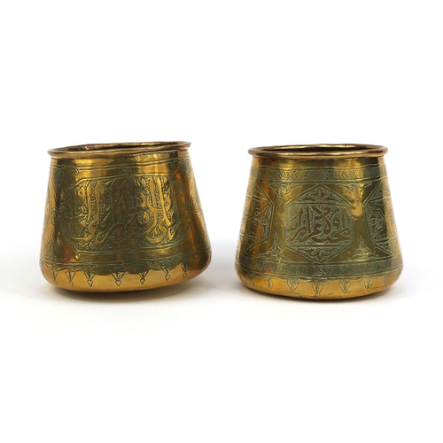 627 - Two Islamic Cairoware brass pots, both engraved with script, each 10cm high