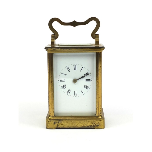 1099 - Brass cased carriage clock striking on a bell with bevelled glass, enamelled dial and Roman numerals... 