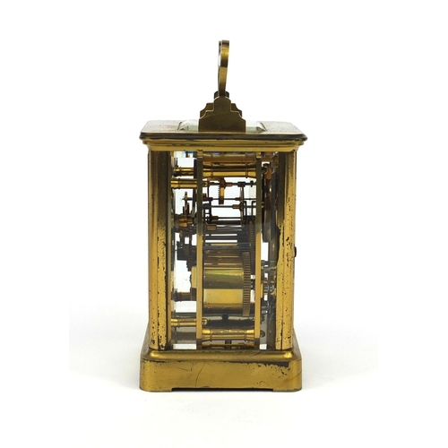 1099 - Brass cased carriage clock striking on a bell with bevelled glass, enamelled dial and Roman numerals... 