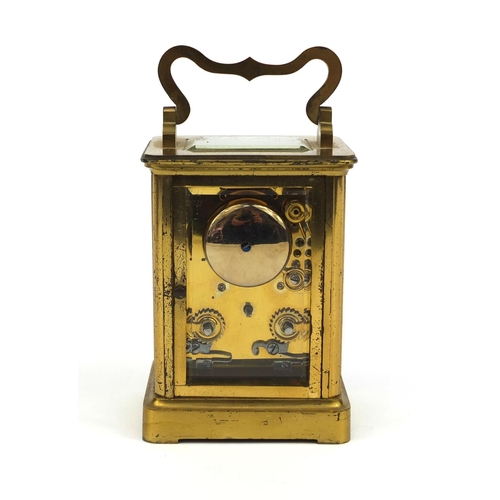 1099 - Brass cased carriage clock striking on a bell with bevelled glass, enamelled dial and Roman numerals... 