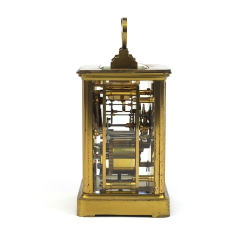 1099 - Brass cased carriage clock striking on a bell with bevelled glass, enamelled dial and Roman numerals... 