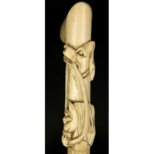 165 - Bone walking stick/crop handle carved with a dog and horse, 13.5cm high