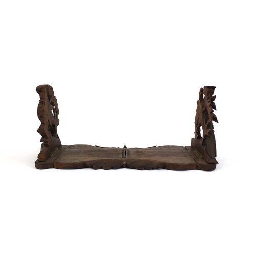 26 - Black forest extending book slide, the fold up ends carved with game, 39cm wide unextended