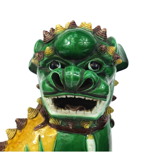 486 - Large pair of Chinese green and yellow glazed Foo Dogs, raised on square bases, each 41cm high