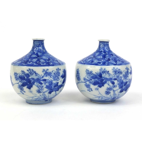 503 - Pair of Japanese blue and white porcelain vases, hand painted with flowers and foliage, each 10cm hi... 