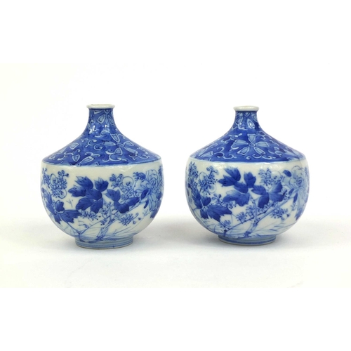 503 - Pair of Japanese blue and white porcelain vases, hand painted with flowers and foliage, each 10cm hi... 