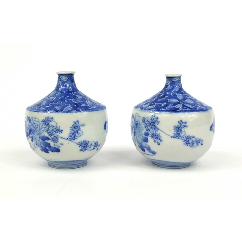 503 - Pair of Japanese blue and white porcelain vases, hand painted with flowers and foliage, each 10cm hi... 