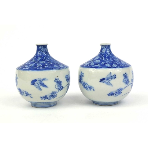 503 - Pair of Japanese blue and white porcelain vases, hand painted with flowers and foliage, each 10cm hi... 