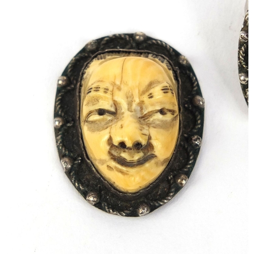 535 - Three Japanese carved ivory devil faces, one mounted as a ring, each 3.2cm high