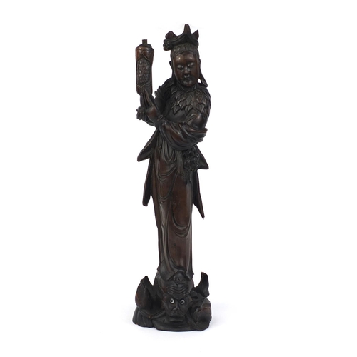 542 - Chinese root lamp base carved as a robed female standing upon a dragon, 52cm high