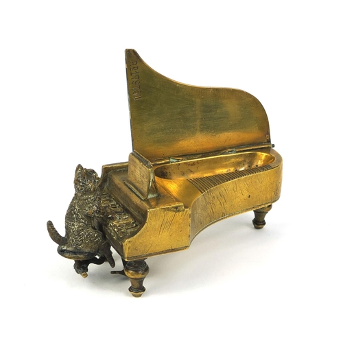 106 - 19th century cold painted bronze match striker, in the form of a cat playing a grand piano, the hing... 