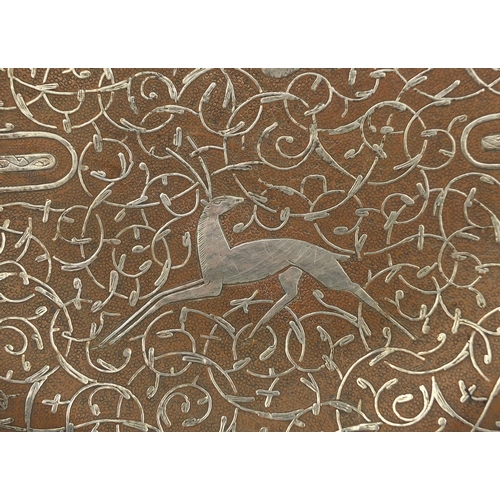 626 - Islamic copper and silver inlaid Cairoware dish, decorated with a leaping deer amongst script and fo... 