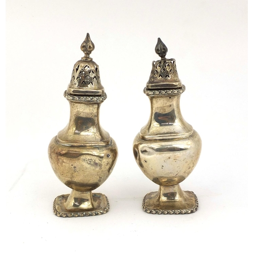 864 - Pair of silver baluster shaped castors, indistinct makers mark, Chester 1923, 13cm high, approximate... 