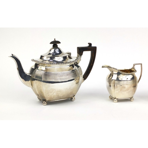 812 - Victorian silver three piece tea service with ball feet, the sugar bowl and milk jug with gilt inter... 