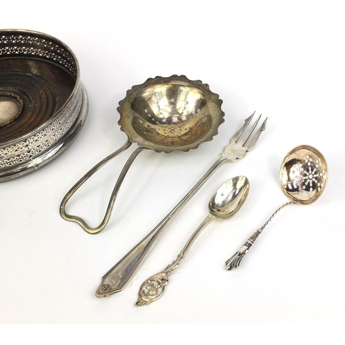 871 - Silver items comprising circular wine coaster, two sifting spoons, pair of napkin rings, teaspoon an... 