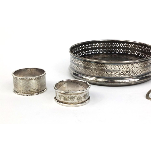 871 - Silver items comprising circular wine coaster, two sifting spoons, pair of napkin rings, teaspoon an... 