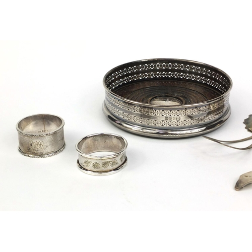 871 - Silver items comprising circular wine coaster, two sifting spoons, pair of napkin rings, teaspoon an... 