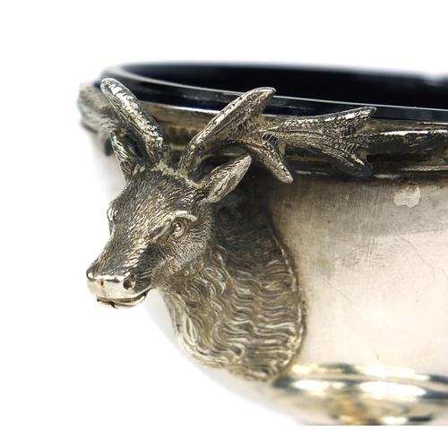 856 - Unmarked silver pedestal salt with applied stag head decoration and blue glass liner, stamped J.L.W ... 