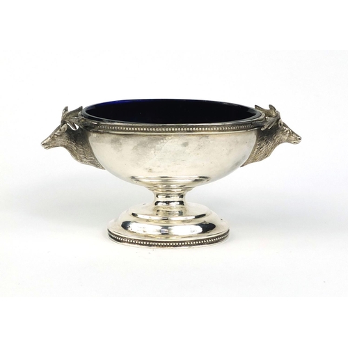 856 - Unmarked silver pedestal salt with applied stag head decoration and blue glass liner, stamped J.L.W ... 