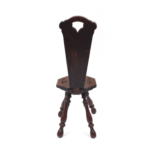 2051 - Carved oak four legged spinning chair with octagonal seat 85cm high