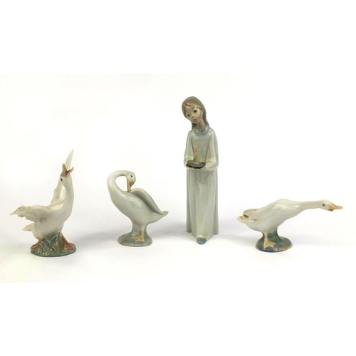 2077 - Three Lladro ducks together with a Nao figure of a girl holding a candle, the largest 21cm high