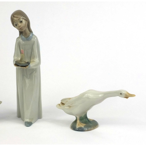 2077 - Three Lladro ducks together with a Nao figure of a girl holding a candle, the largest 21cm high