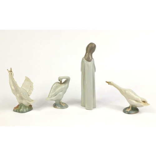 2077 - Three Lladro ducks together with a Nao figure of a girl holding a candle, the largest 21cm high