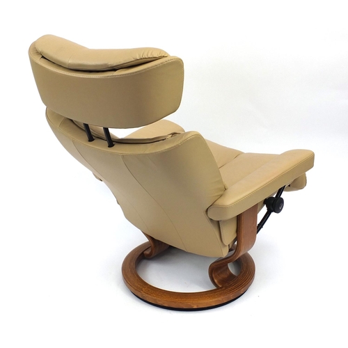 2001 - Stressless beige leather chair with foot stool, the chair 106cm high