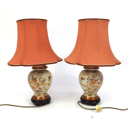 2123 - Pair of Oriental table lamp vases and covers, with silk lined salmon shades, both hand painted with ... 