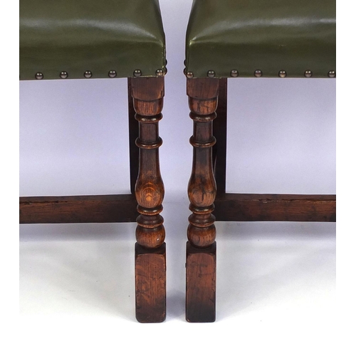 2018 - Set of six carved oak dining chairs including two carvers, each with green leather upholstered seats... 