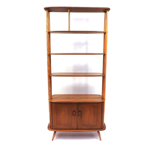 2005 - Ercol light elm room divider fitted with three shelves above a pair of cupboard doors, the shelves i... 