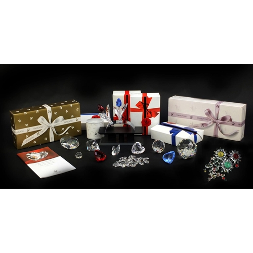 2103 - Collection of mostly boxed Swarovski Crystal including a swan, love hearts, flowers and stands, the ... 