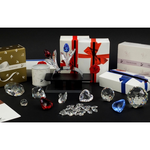 2103 - Collection of mostly boxed Swarovski Crystal including a swan, love hearts, flowers and stands, the ... 