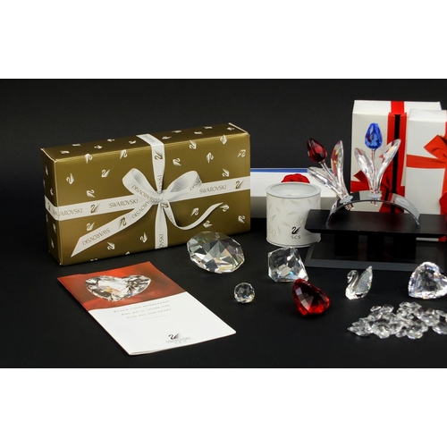 2103 - Collection of mostly boxed Swarovski Crystal including a swan, love hearts, flowers and stands, the ... 