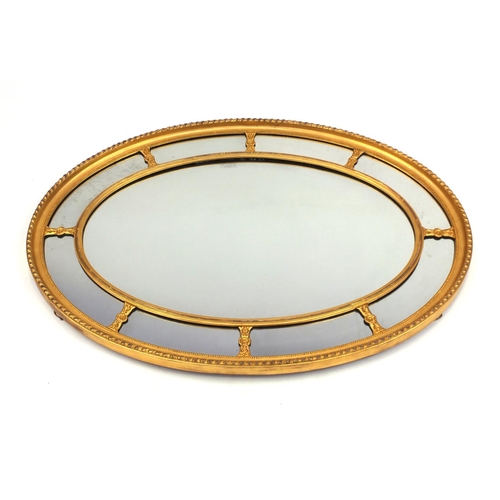 2019 - Large oval gilt framed sectional mirror, 110cm x 82cm
