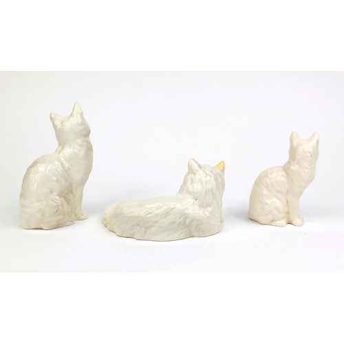 2080 - Three Beswick cats including an example laying down, each with factory marks and numbers to the base... 