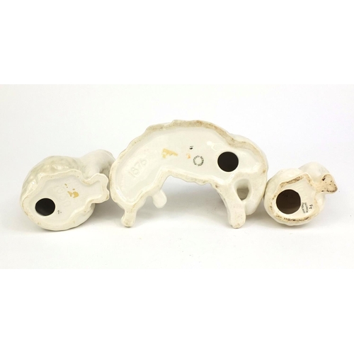 2080 - Three Beswick cats including an example laying down, each with factory marks and numbers to the base... 