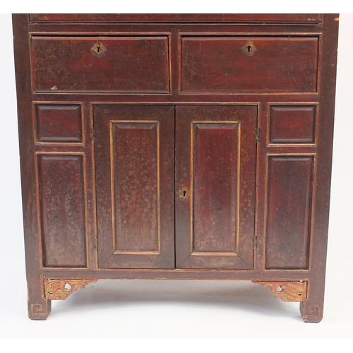 102 - Oriental display cabinet with glazed doors enclosing three shelves above an arrangement of drawers a... 