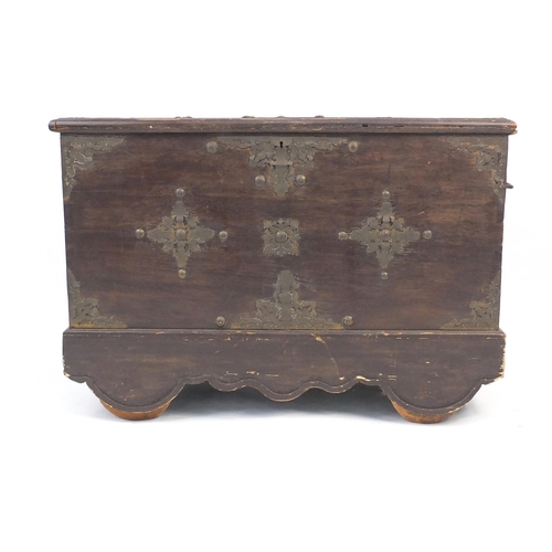 47 - Indian stained hardwood chest with brass mounts and wooden wheels, 70cm high x 100cm wide x 50cm dee... 
