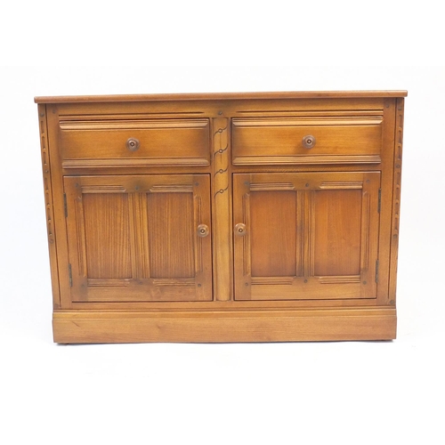 49 - Ercol elm side cabinet fitted with two drawers and two cupboards and a matching pedestal cupboard fi... 