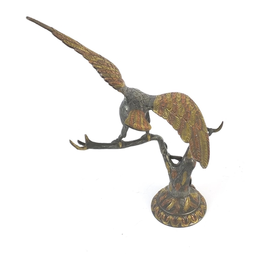 132 - Metal study of an eagle and a snake on a branch, 36cm high