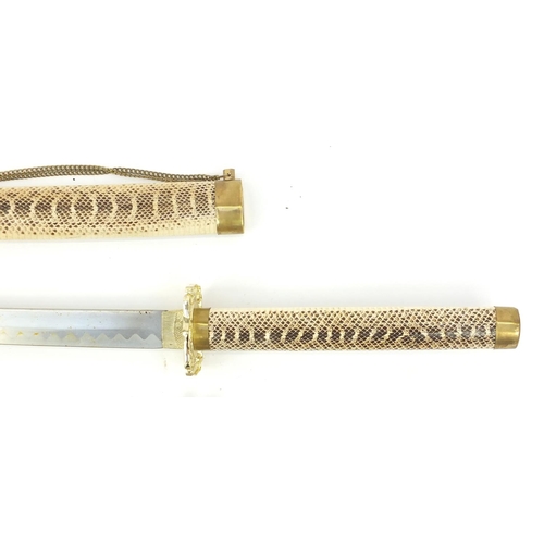 193 - Graduated set of three decorative Japanese Samurai swords with simulated snake skin, the larger 101c... 