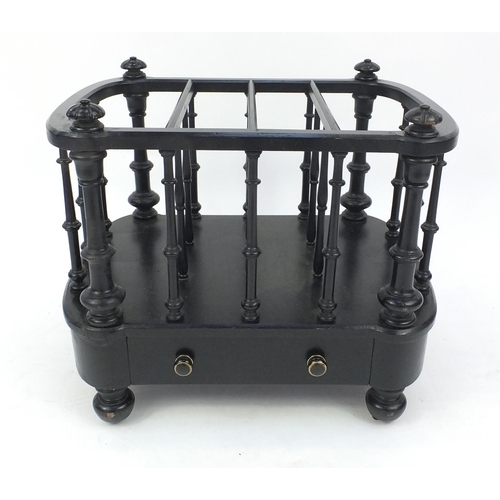 25 - Victorian ebonised four section Canterbury fitted with a drawer