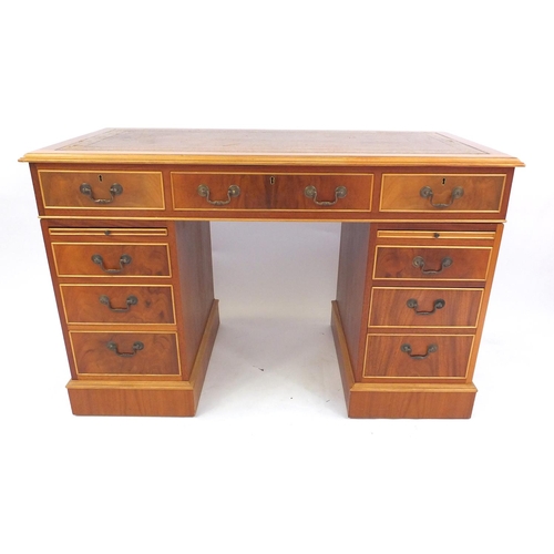 1 - Reproduction yew wood twin pedestal desk fitted with an arrangement of nine drawers
