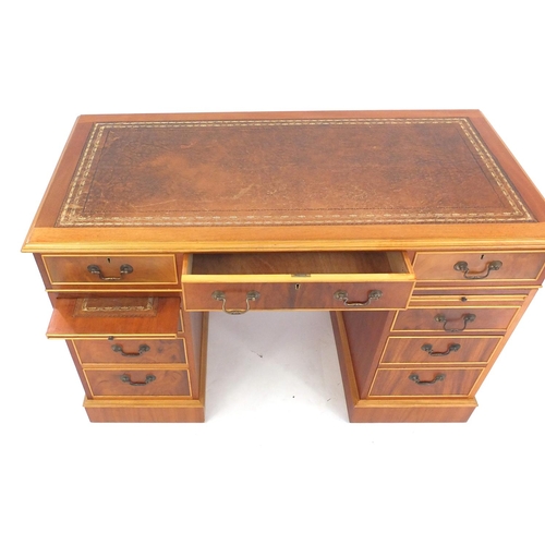1 - Reproduction yew wood twin pedestal desk fitted with an arrangement of nine drawers