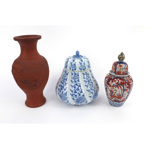 408 - Group of Oriental ceramics comprising a terracotta baluster vase, Imari vase and cover and one other... 