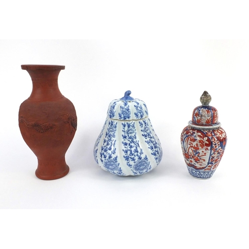 408 - Group of Oriental ceramics comprising a terracotta baluster vase, Imari vase and cover and one other... 